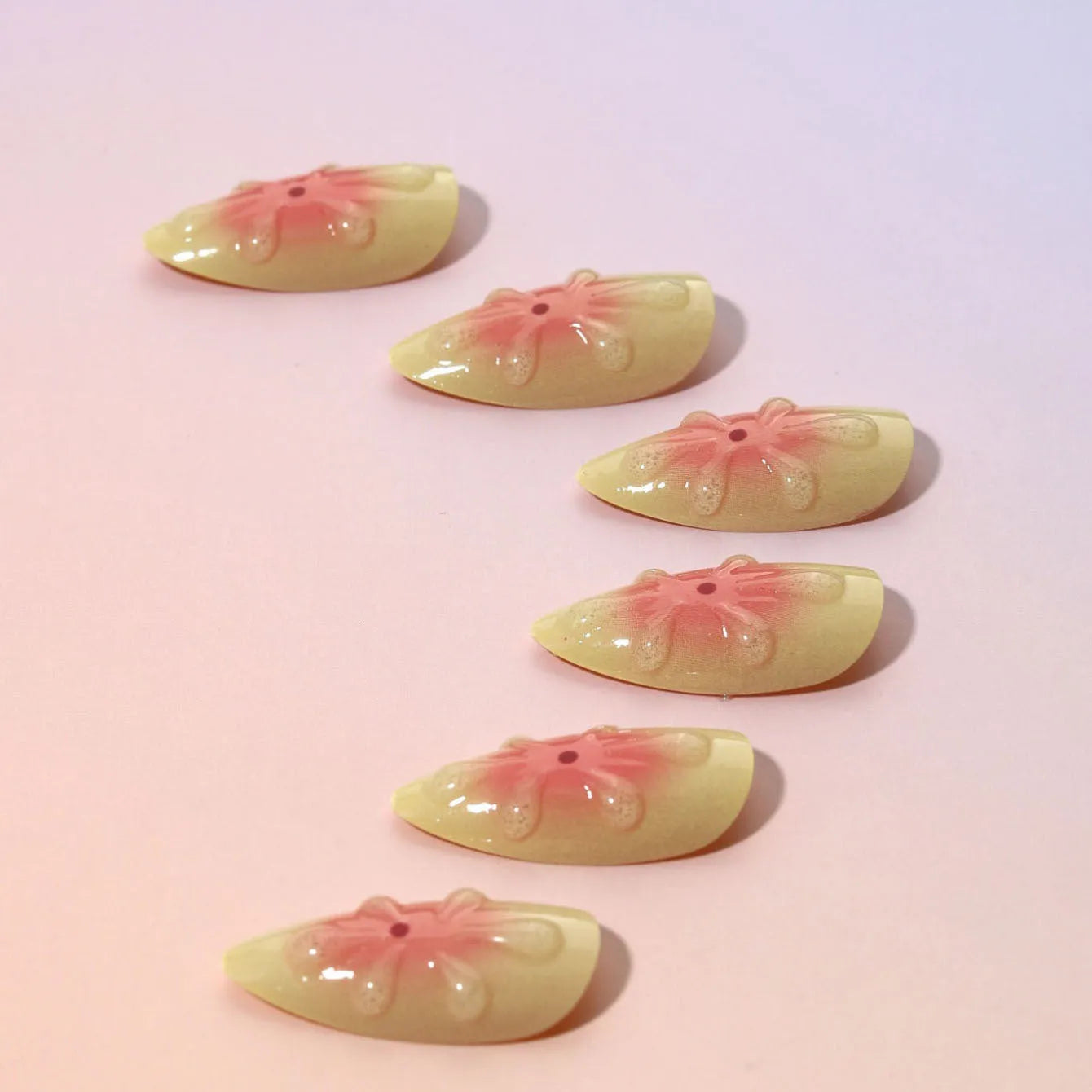 Simple fake nails with 3D cartoon flower designs, plastic wearable armour pieces, jelly glue and filing strip