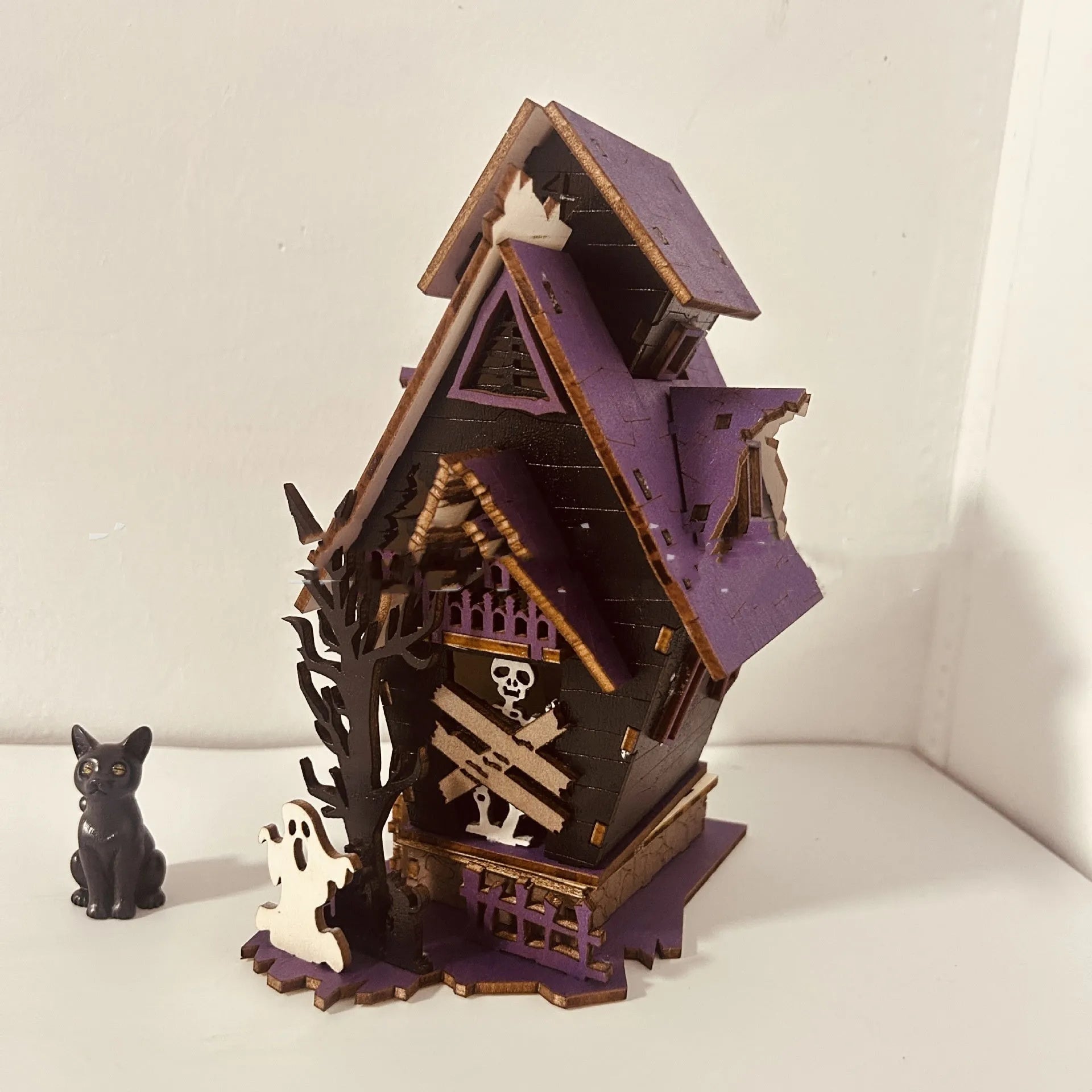 Wooden glowing haunted house Halloween table decoration with candlestick holder, 14cm wide.