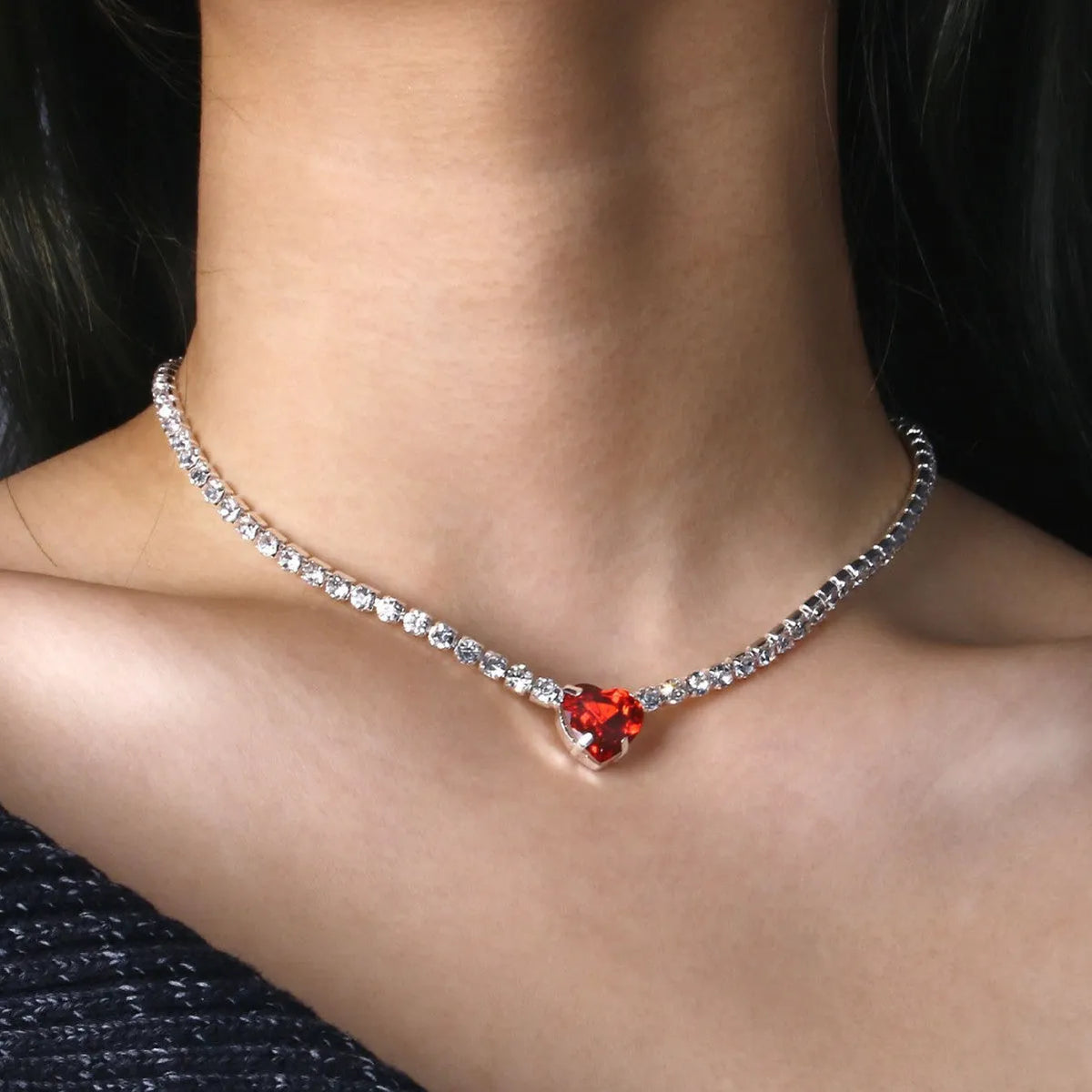 Heart pendant necklace with rhinestone crystal on a 41-50cm box chain, available in gold or silver finish.