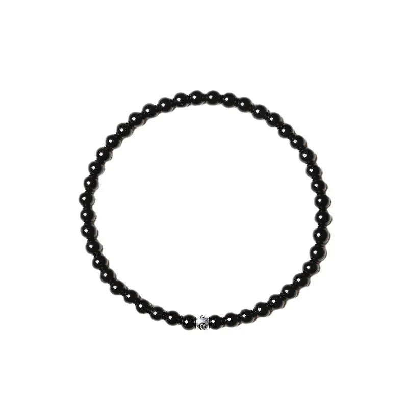 Fine geometric bracelet with black obsidian, blue san, and black agate 4mm beads on an adjustable band.