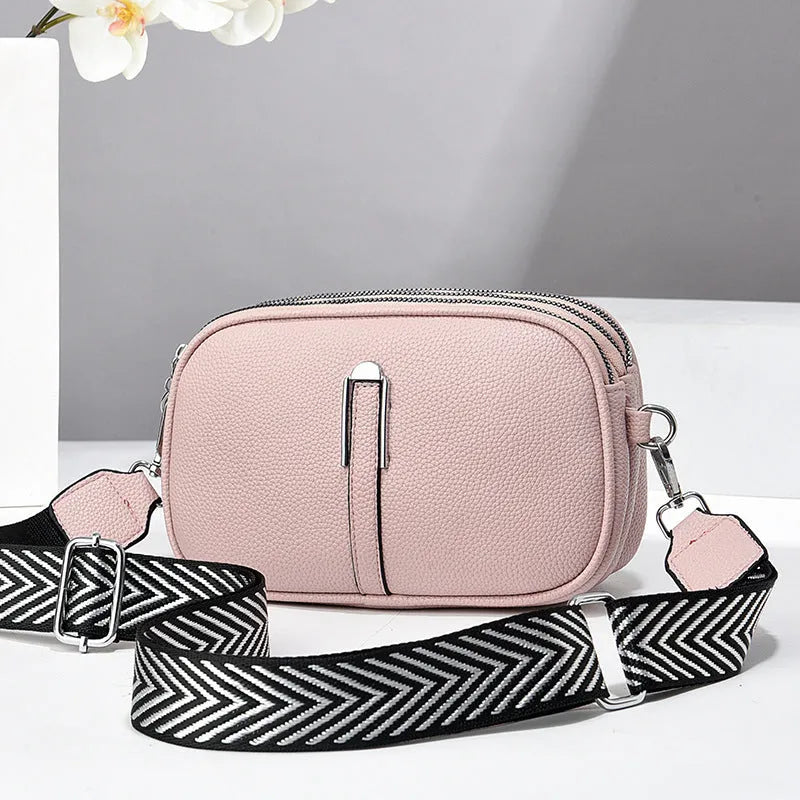 Women's soft PU crossbody bag in oval shape with interior organisation compartments
