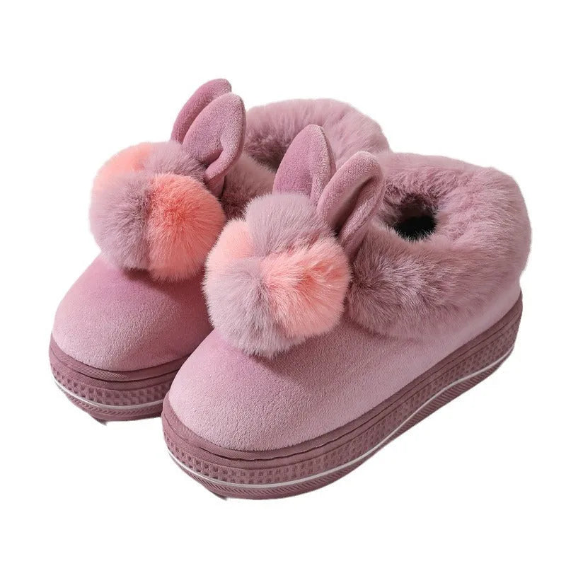 Pair of grey cotton plush high heel slippers with a thick TPR sole, shown on a wooden floor.