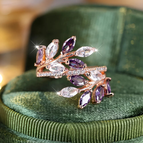 Adjustable leaf ring with horse eye zircon stone in rose gold finish on wooden background