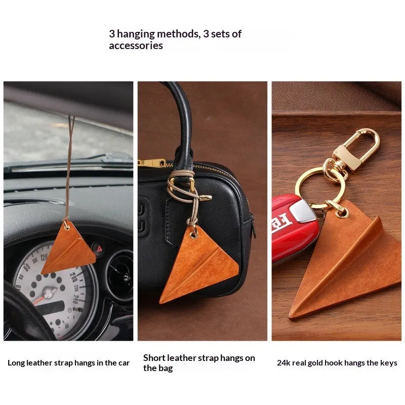 Crazy Crafts handmade cowhide paper airplane pendant in brown, on a bag
