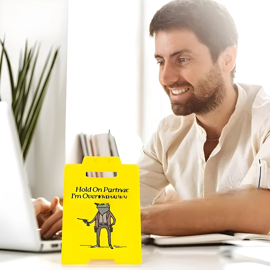 Yellow plastic humour desk decoration with simple modern design on a shelf