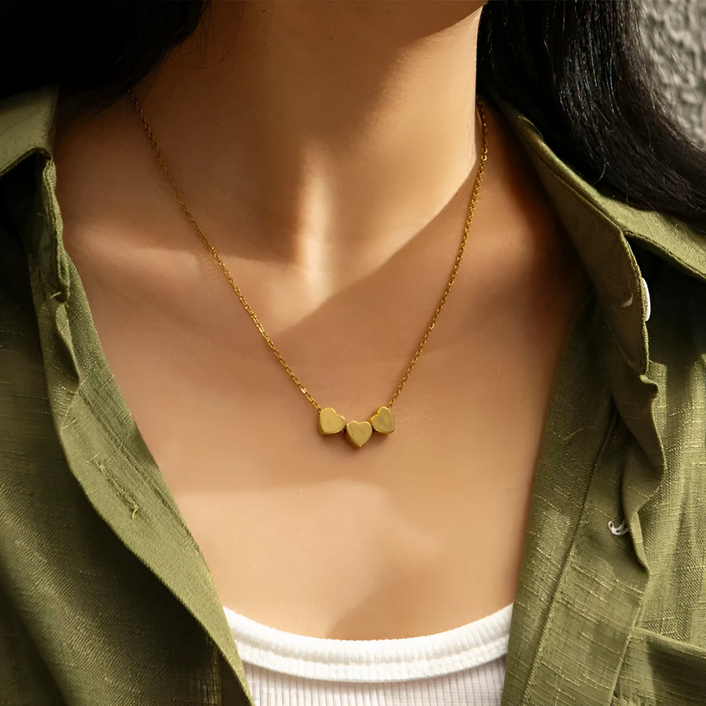Gold stainless steel three-heart pendant necklace with laser-engraved black text on O-chain