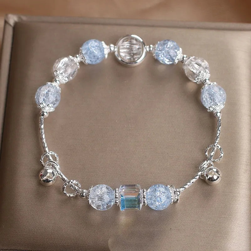 Light blue artificial crystal bell bracelet on woman's wrist