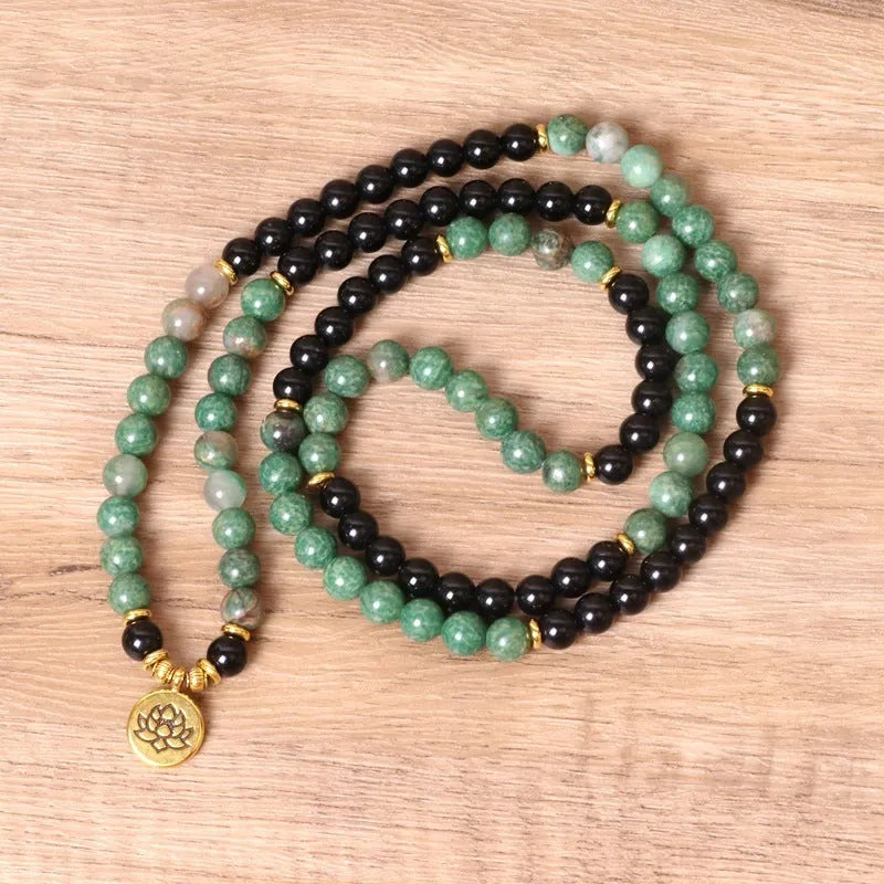 Green and black elastic beaded alloy bracelet showing stretch design and natural style