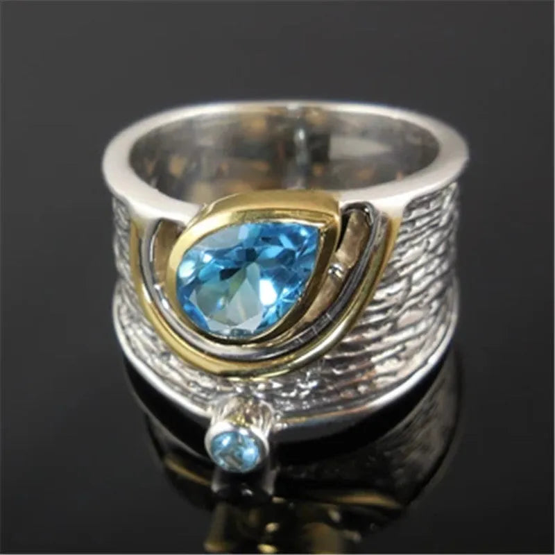 Close-up of a blue zircon and rhinestone drop-shaped ring in a Chinese style design.