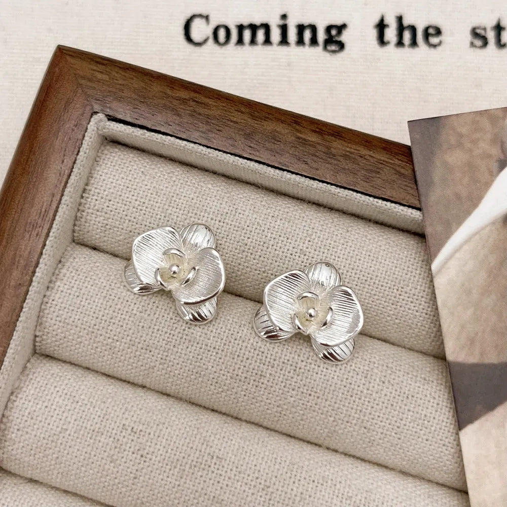 Retro flower earrings with gold or silver electroplated finishes and detailed petal design elements