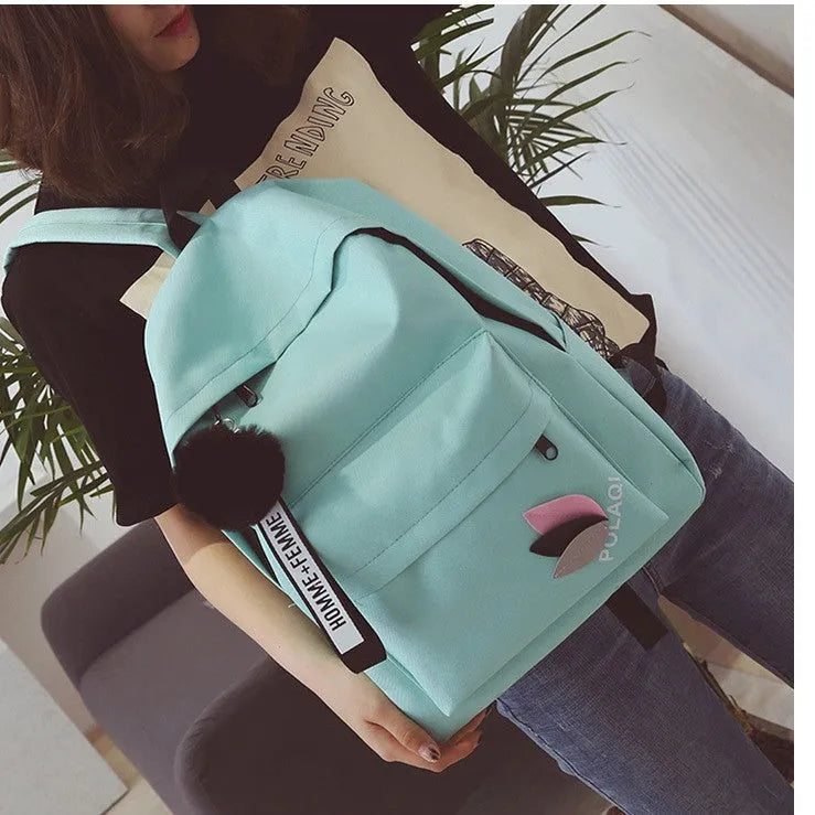Green canvas college style schoolbag with structured design showing 40cm height and front compartment