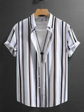 Man wearing a loose-fitting striped short sleeve shirt with a stand collar.