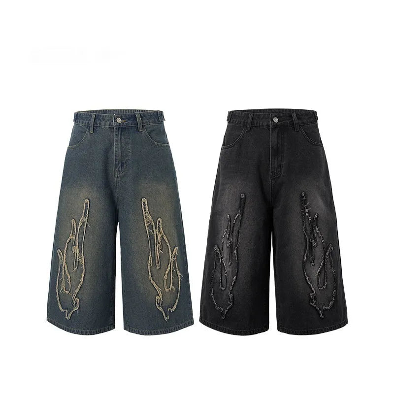 Men's black cropped denim shorts with flame embroidery patches on straight-leg cut