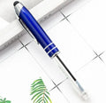 Red metal capacitive stylus and ballpoint pen with a built-in LED light on a desk next to a tablet.