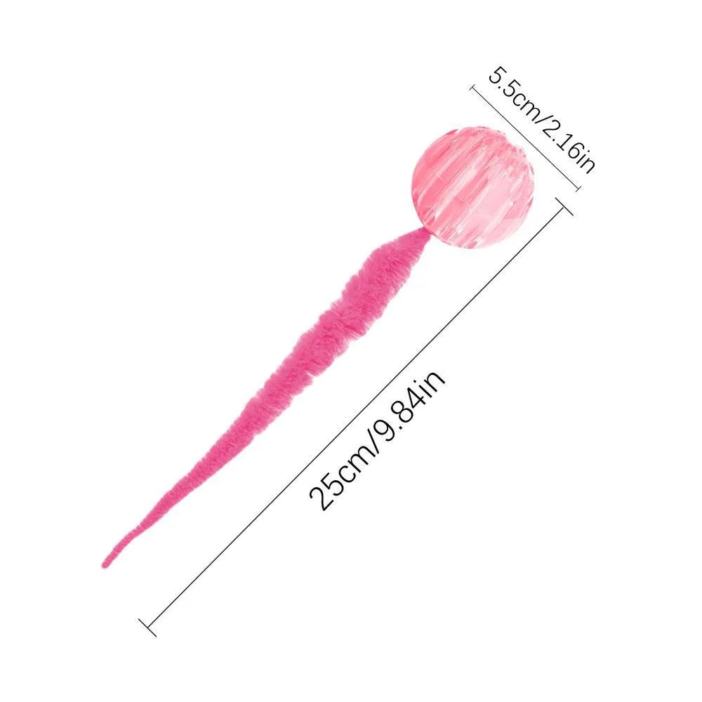 Interactive cat ball toy with elastic worm tail in green colour on wooden floor