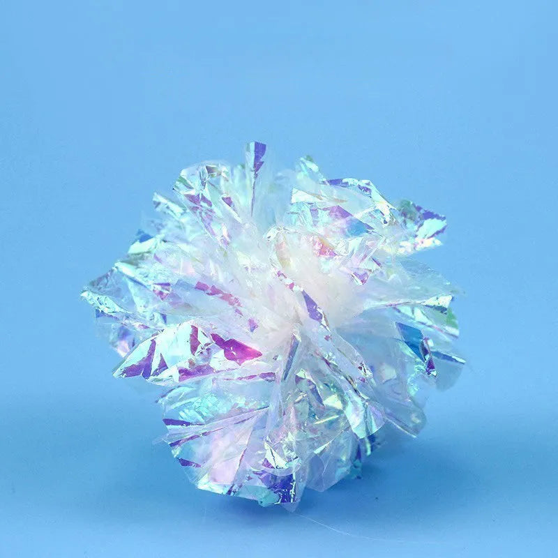 White noise-making paper ball cat toy on floor for indoor cat play