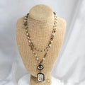 Beige and blue two-layer tribal style necklace with glass pendant and stone accents on adjustable chain