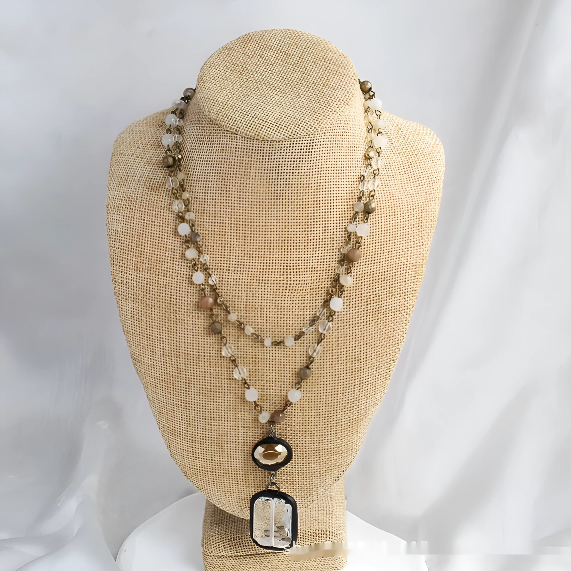 Beige and blue two-layer tribal style necklace with glass pendant and stone accents on adjustable chain