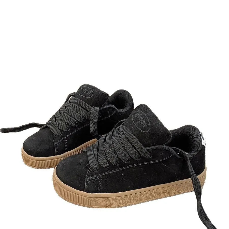 Black retro low-top sneakers with a platform sole and front lace-up closure on a white background.