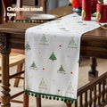 Green Christmas table runner with tree pattern on a dining table, 35cm wide polyester imitation linen