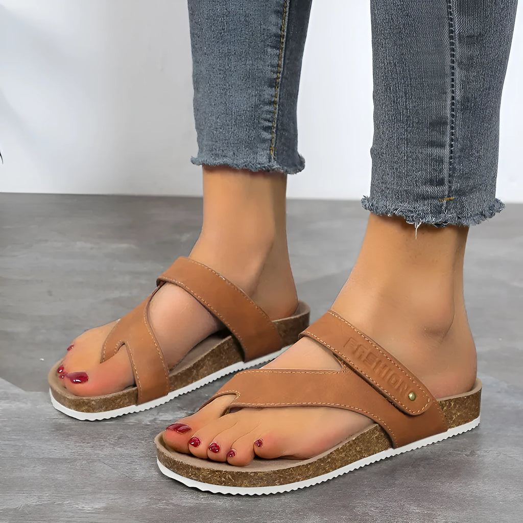 Women's flat toe ring flip-flops in blue with a thick foam sole, shown from the side.