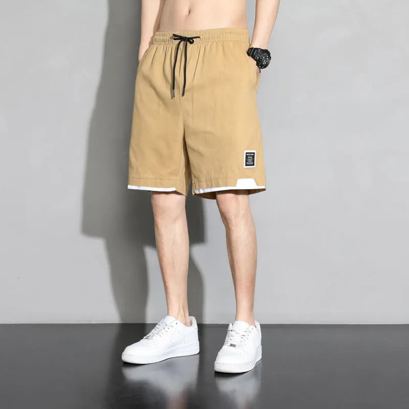 Boys' black cotton casual shorts with mid-waist, shown on a hanger.