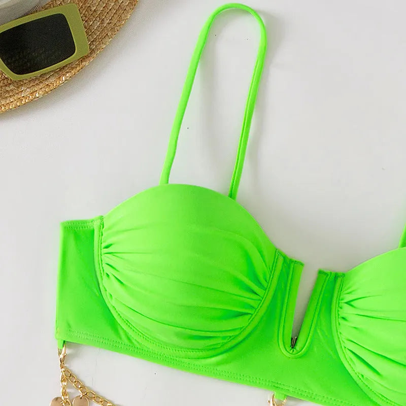 Women's solid colour bikini set in grass green, showing bra top and panty bottom on a plain background