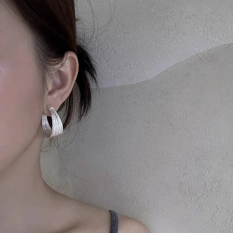 Geometric copper earrings with electroplated silver or gold finish, shown as stud and clip-on styles