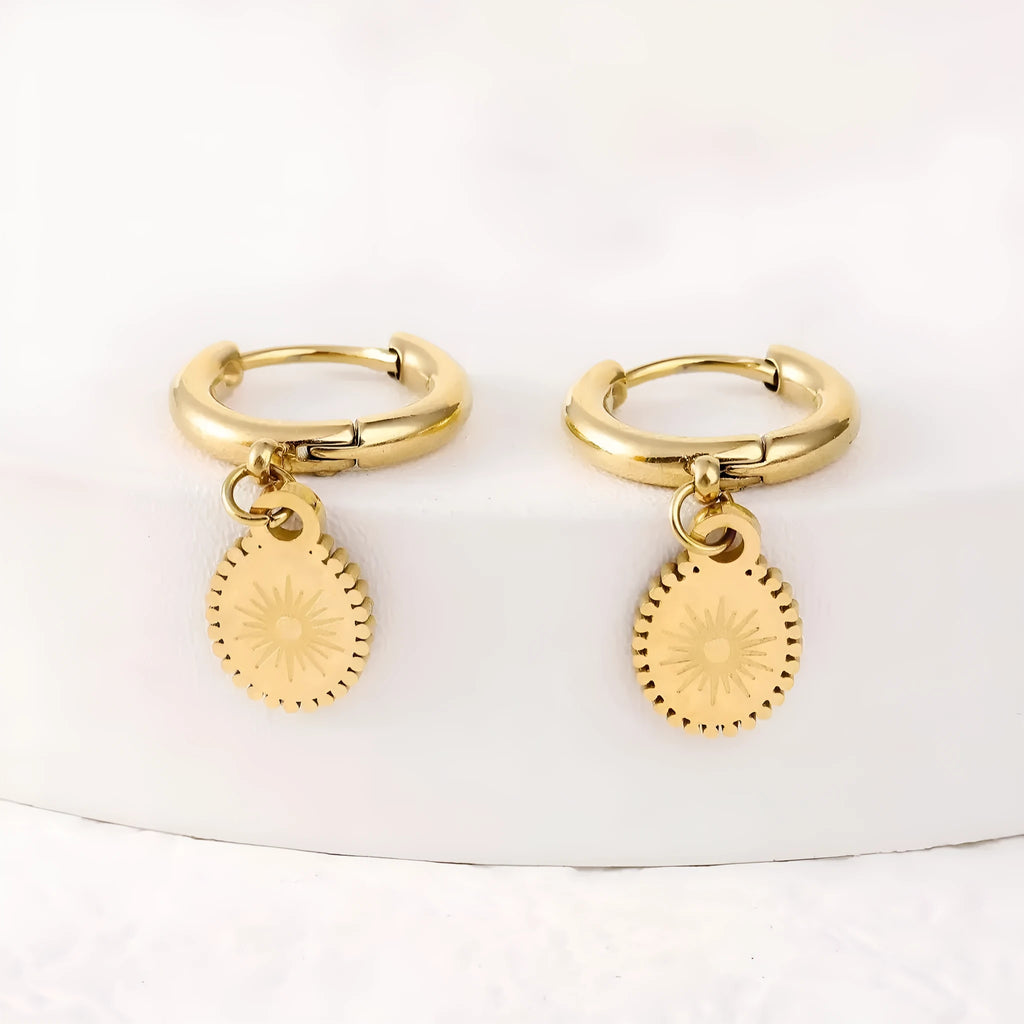 A pair of geometric stainless steel ear button earrings with an ellipse detail, shown in colour XY-EH005.