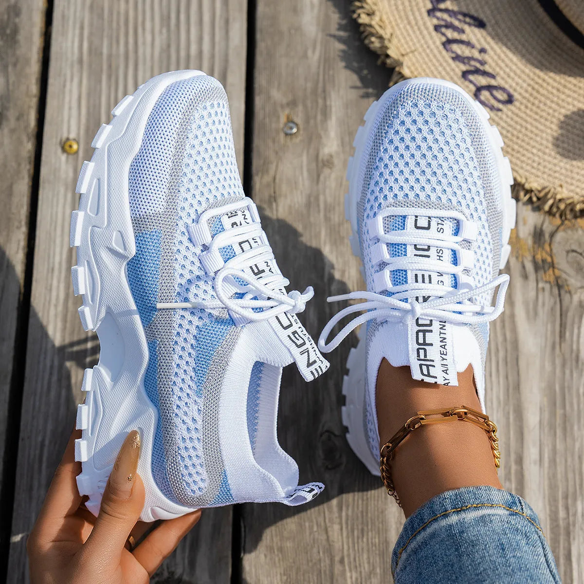 Women's Flyknit mesh lace-up sneakers in low flat heel design for walking and running