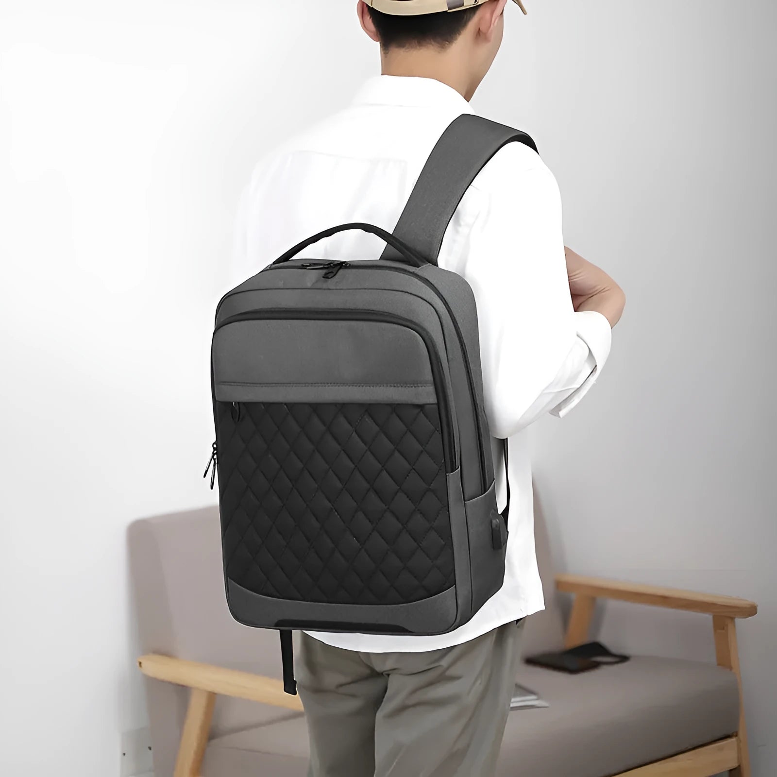 Men's Oxford cloth travel backpack in black with curved shoulder straps and diamond mesh panels