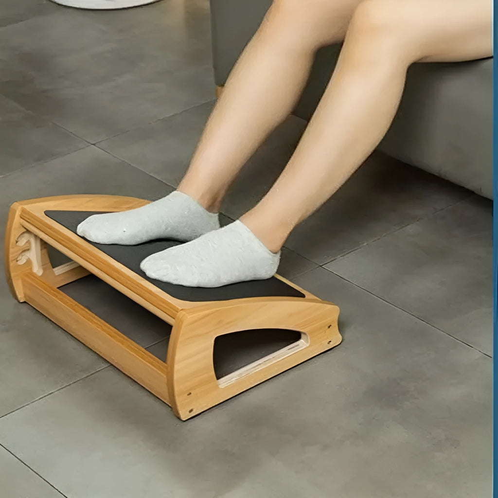 Wooden adjustable bamboo office desk footstool in natural wood colour.