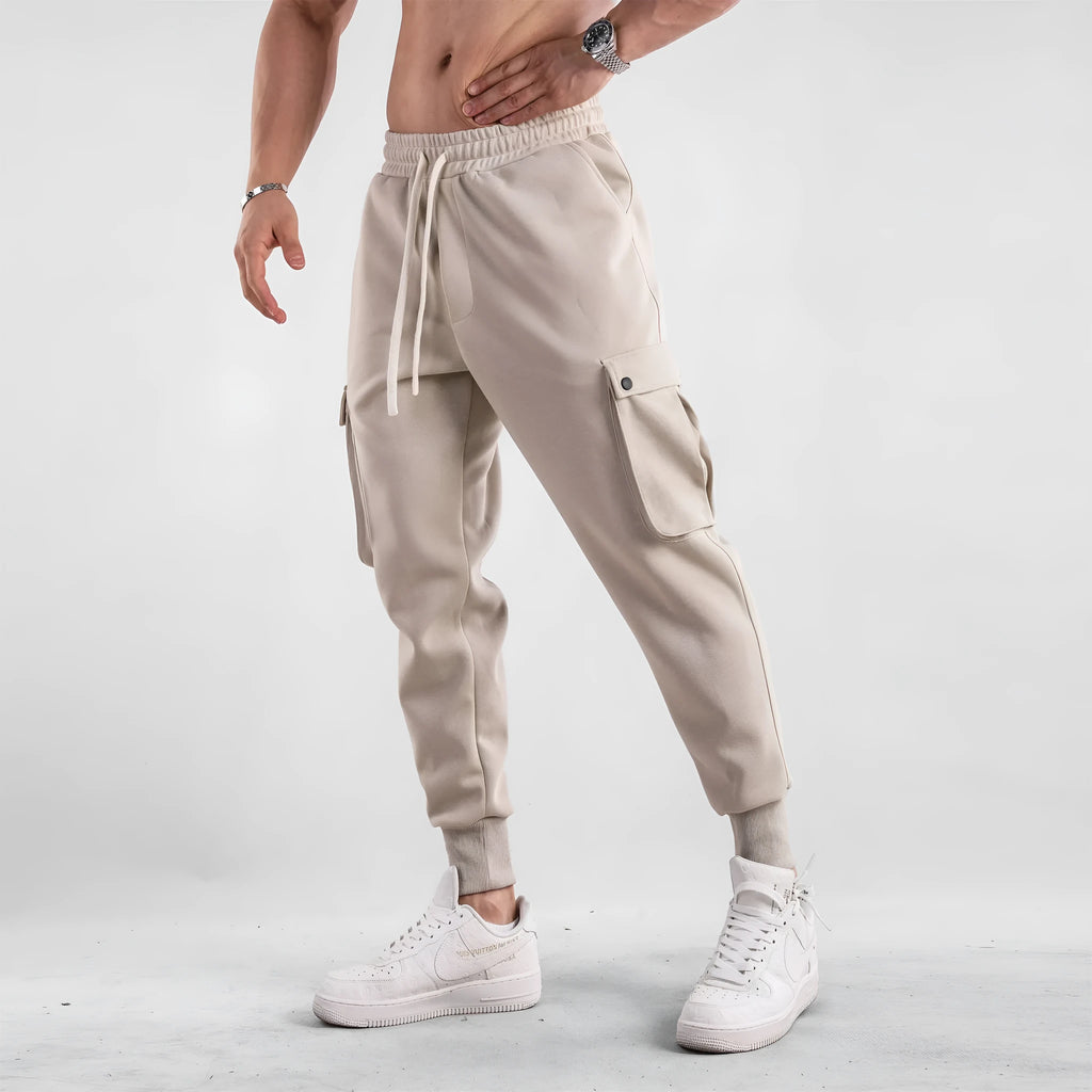 Men's loose fit cotton sports trousers with ankle ties in apricot colour showing multiple pockets