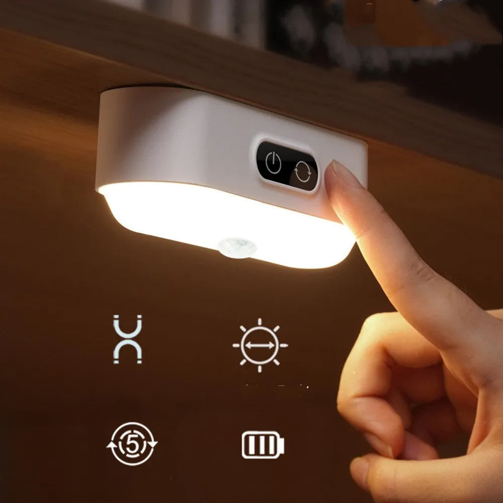 White magnetic USB rechargeable LED night light with touch controls and a curved light surface.