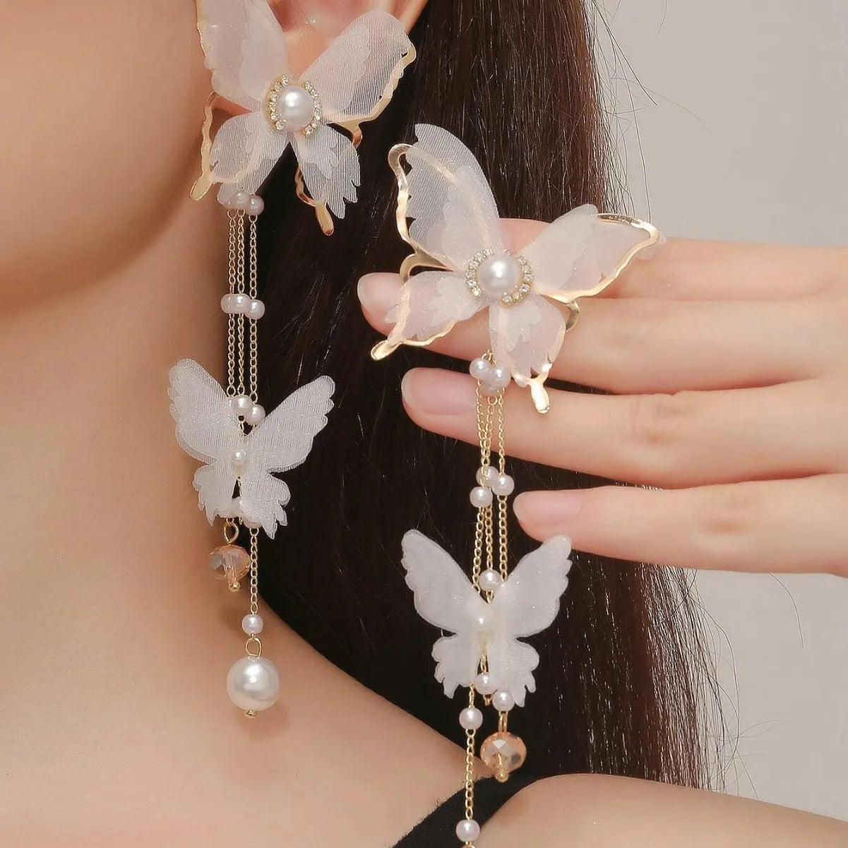 White butterfly earrings with tassel lace and pearl rhinestone decorative elements on copper alloy