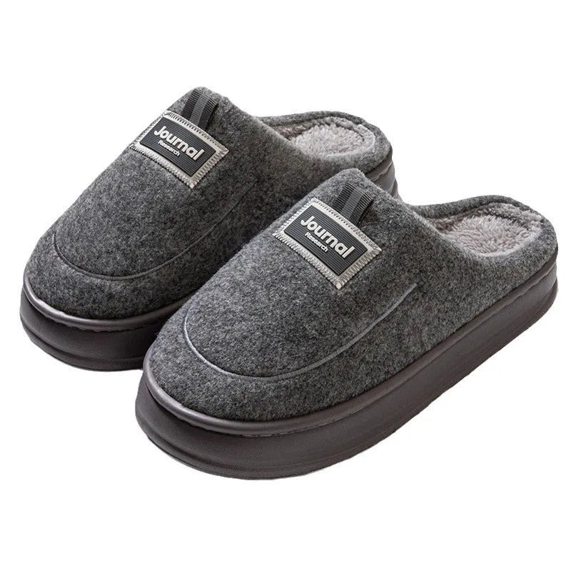 Men's brown suede slippers with thickened sole on wooden floor