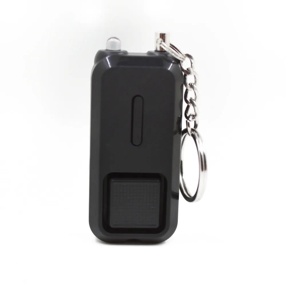 Compact pink personal safety alarm keyring with a button, shown next to its white retail box.