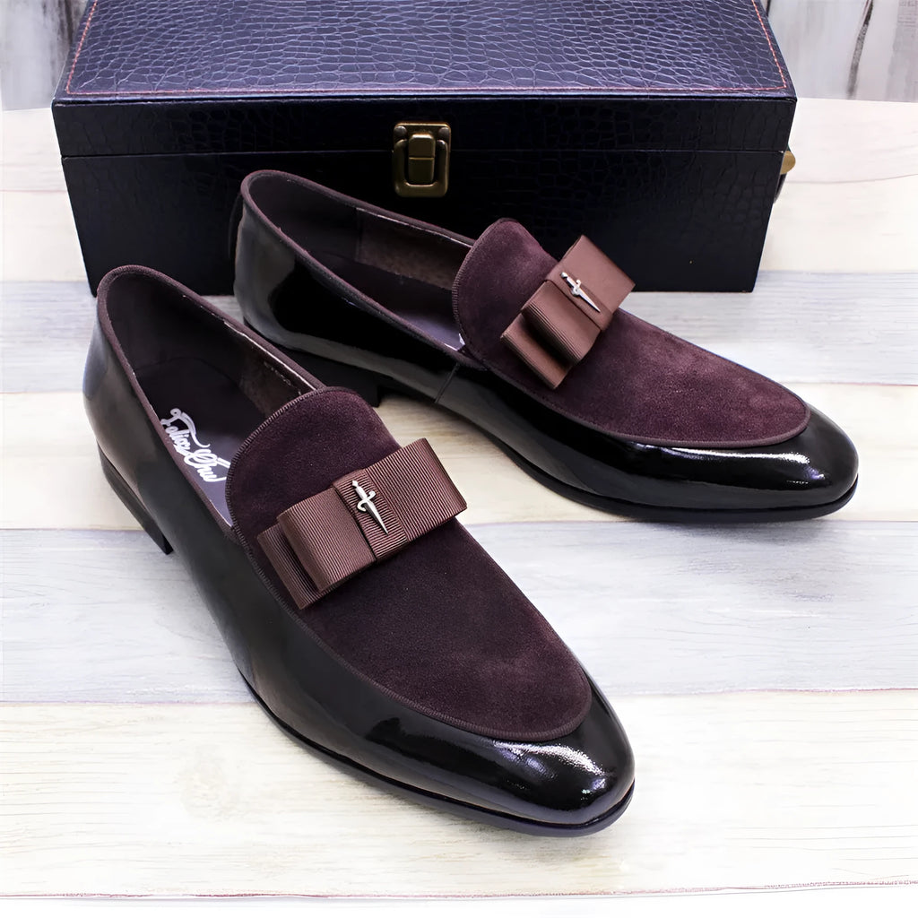 Men's glossy patent leather dress shoes with tassel detail in black, showing low-top design and leather toe holder.