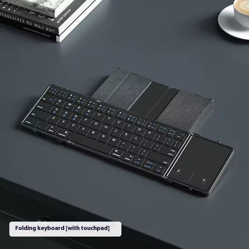 Black folding Bluetooth keyboard for mobile phones and tablets showing compact folded design