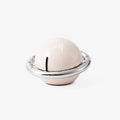 Beige mechanical kitchen timer with manual twist dial and magnetic back on metal surface