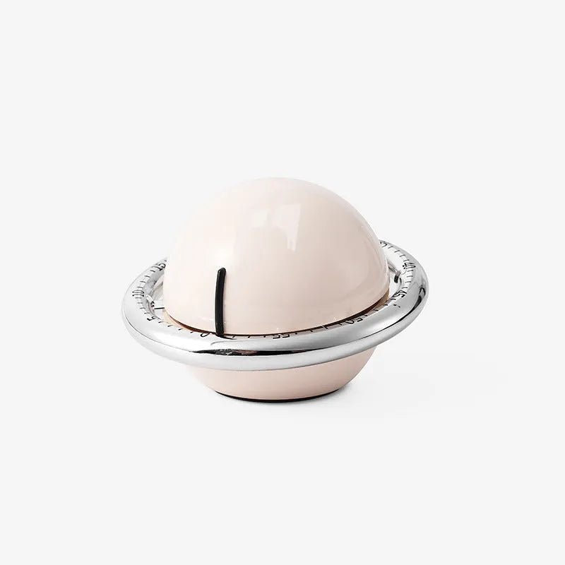 Beige mechanical kitchen timer with manual twist dial and magnetic back on metal surface