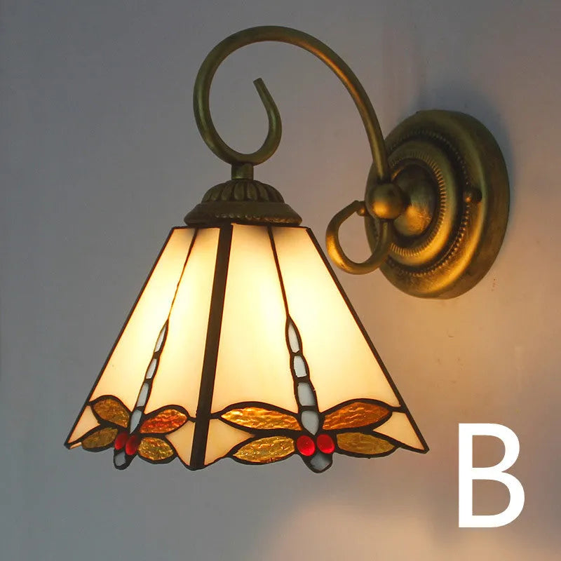 A coloured stained glass wall lamp mounted on a corridor wall, showing one of six available style variants.