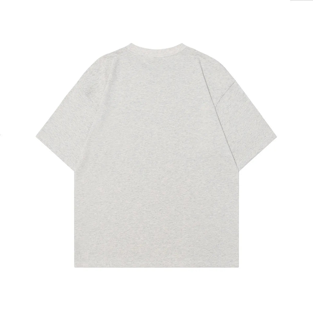 Men's grey loose-fit t-shirt featuring a retro character print design on the front.