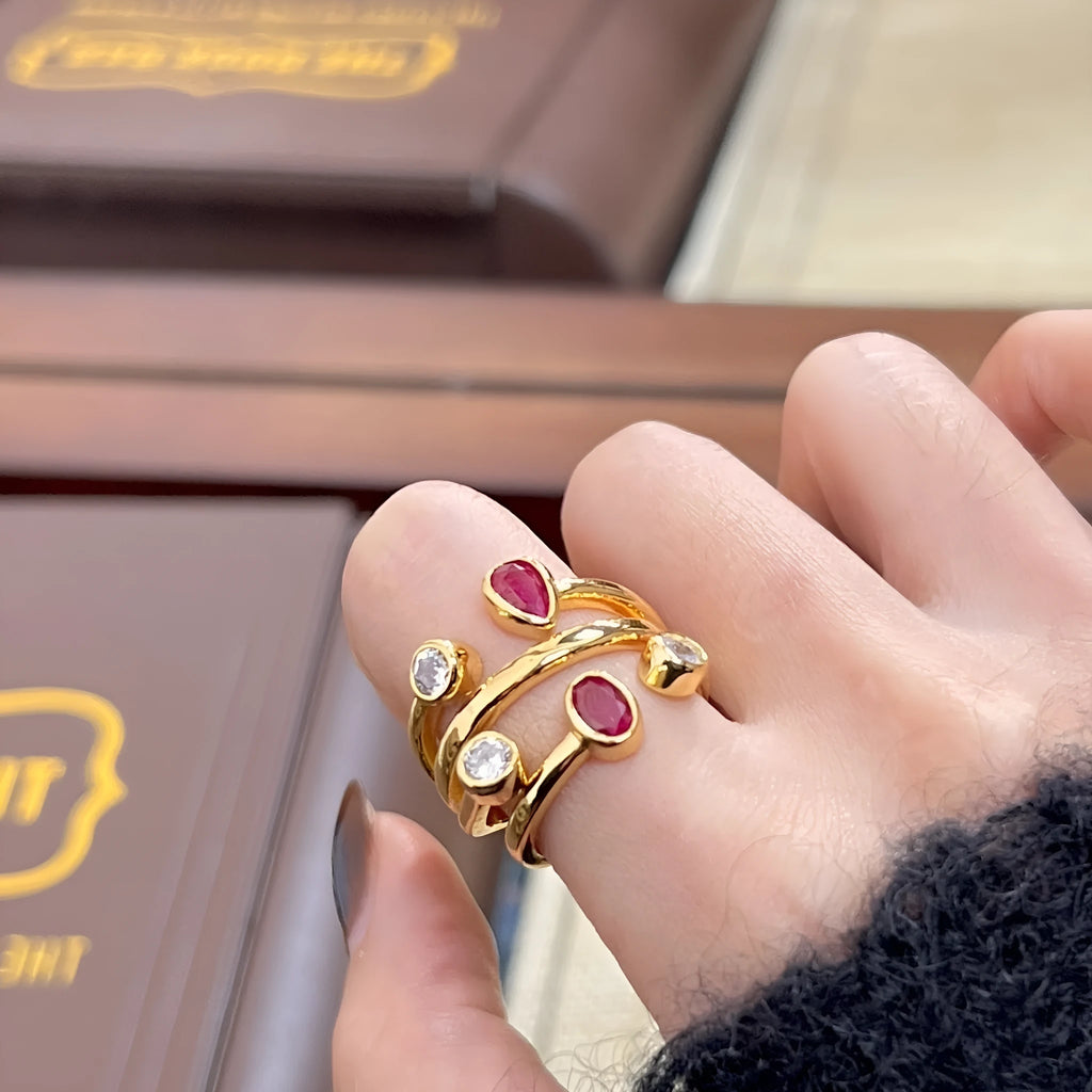 Geometric two-tone ring with an irregular cross design and group diamond details on a copper band.