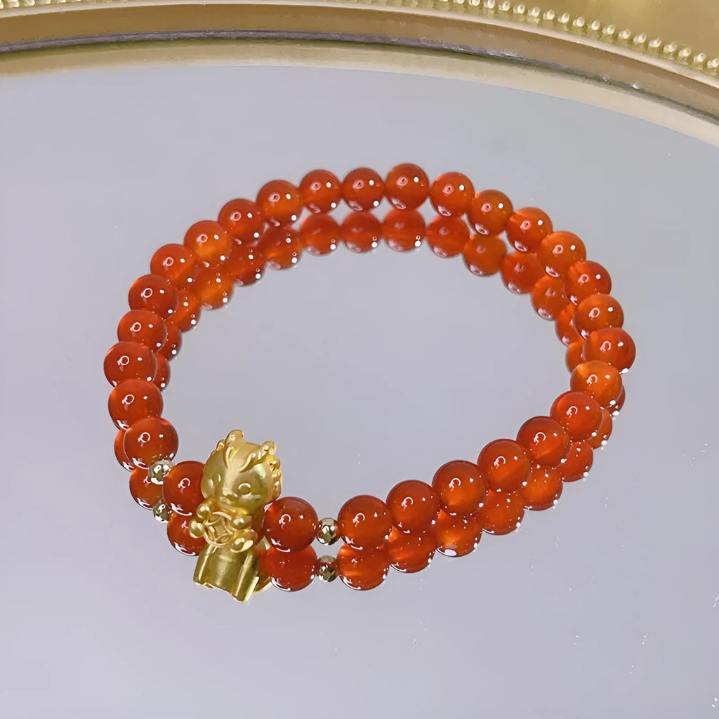 A red agate bracelet for women with a manual crafted dragon design in Chinese style.