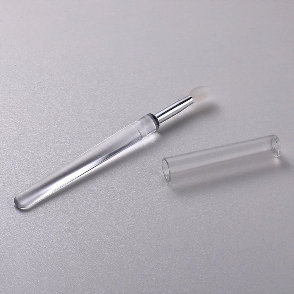 Set of four reusable silicone lip brushes with caps in assorted colours.