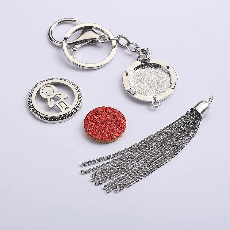 Alloy metal car fragrance pendant with tassel on a 50cm chain, shown with scented cotton pieces.