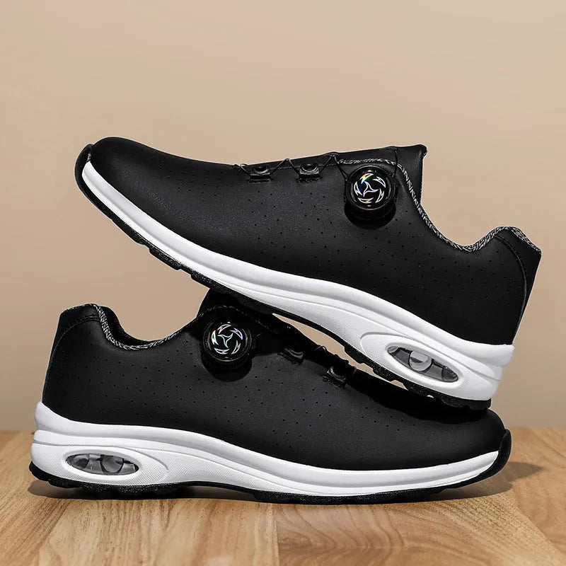 Black and white low top casual tennis shoes with mesh upper, cross shoulder straps, and composite sole.