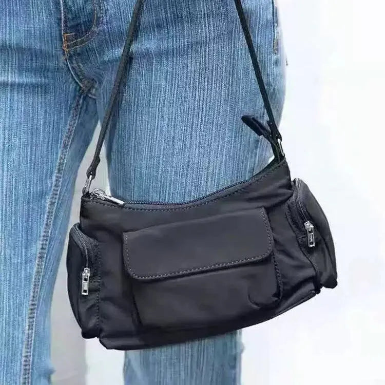Black lightweight women's shoulder bag with double pockets showing side line detailing