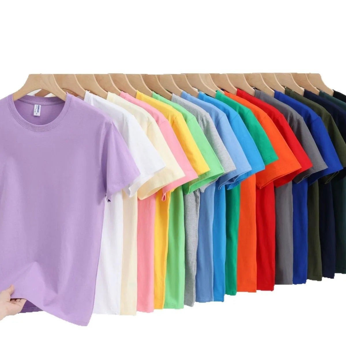 Men's and women's loose-fit cotton T-shirt in solid colours like navy blue, red, and white, shown as a short-sleeve pullover top.